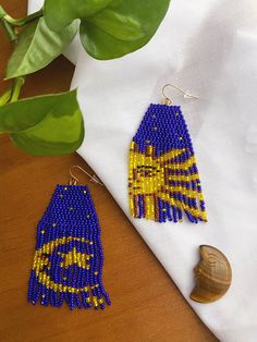 90s celestial whimsigoth long fringe beaded earrings  Inspired by the iconic celestial Libbey glassware from the 1990's. Whimsigoth moon and sun with sparkly firefly gold stars and cobalt blue beaded background. The gold beads have a firefly effect making them extra shimmery in the light.  Woven by hand with glass seed beads Measures 3 1/2 inches in length 14K gold plated earring hooks (lead free, nickel free, cadmium free and hypoallergenic) Lightweight on the ears Whimsigoth Moon, Celestial Whimsigoth, Beaded Moon Earrings, Seed Bead Moon Earrings, Sun And Moon Beaded Earrings, Moon Brick Stitch Earrings, 90s Celestial, Native American Beadwork Earrings Moon & Milk, Fringe Beaded Earrings