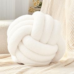 a pile of white towels sitting on top of a couch