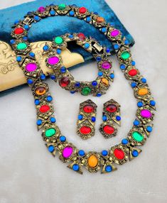 Absolutely gorgeous vibrant gem-toned cabachons set in heavy gold tone metal, with ALL THREE pieces (necklace, earrings, bracelet) of the set still together which is almost unheard of! This set came from an estate and is a classic 1980s-does-1940s style.  This set has sold for up to $400 for just the necklace and earrings, so this is a great deal! All are in good condition, please see pictures for details and measurements.  Thanks for looking!