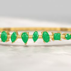 Shine with elegance! This 3.25 Carat Lab Grown Emerald Minimalist Cuff Bangle Bracelet is a stunning May birthstone gift for her. Handcrafted with love, this custom-made jewelry piece features a vibrant emerald gemstone, perfect for birthdays, anniversaries, or just because. Order now and make it a personalized treasure! 𝐅𝐞𝐚𝐭𝐮𝐫𝐞𝐬:• 𝐌𝐚𝐝𝐞 𝐭𝐨 𝐎𝐫𝐝𝐞𝐫• 𝐌𝐞𝐭𝐚𝐥: 𝟏𝟎𝐊 𝐆𝐨𝐥𝐝 | 𝟏𝟒𝐊 𝐆𝐨𝐥𝐝 | 𝟏𝟖𝐊 𝐆𝐨𝐥𝐝 • 𝐁𝐚𝐧𝐝 𝐂𝐨𝐥𝐨𝐫𝐬: Rose Gold, Yellow Gold & White Gold• 𝐖𝐢𝐝 Stacked Wedding Rings, Cuff Bangle Bracelet, May Birthstone, Birthstone Gifts, Band Bracelet, Engagement Rings Oval, Emerald Gemstone, Cuff Bangles, Gold Band