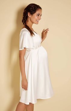 This relaxed bridal dress owes a little inspiration to the easy to wear Kimono. Loose fitting longer sleeves and a subtle v neckline make it easy to style up or down. Light to wear, an easy-breezy elegant summer style for the fuss-free bride. Boho maternity wedding dress Loose-fitting kimono sleeves Blissfully soft satin crepe Flattering gentle V-neckline Floaty fit-and-flare skirt Perfect for all stages of pregnancy. Made in Britain Elegant Maternity Dress In Cream, Elegant White Maternity Wedding Dress, Elegant Cream Maternity Dress, Elegant White Maternity Bridesmaid Dress, Elegant V-neck Wedding Dress For Wedding Night, Elegant White Maternity Dress With V-neck, Elegant White V-neck Maternity Dress, Boho Maternity Wedding Dress, V Font