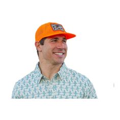 a man wearing an orange hat smiles at the camera while standing in front of a white background