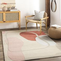 a living room with a chair, rug and other items in the room on the floor