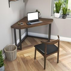 a laptop computer sitting on top of a wooden desk next to a chair and potted plant