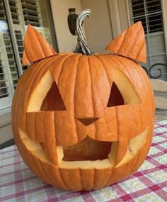 a pumpkin carved to look like a cat