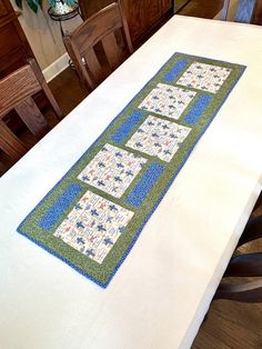 a table with a quilted runner on top of it