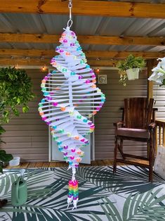 a colorful wind chime hanging from a porch