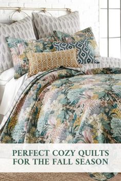 the comforter is made up and has many different patterns on it, including flowers