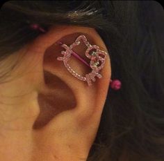 a close up of a persons ear with an ear pin in the shape of a heart