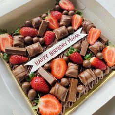 a birthday cake with strawberries and chocolate