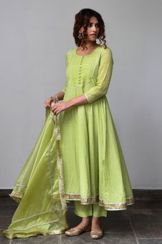 Soft lime anarkali with striped yoke, gota trims and button placket. Paired with pants and organza dupatta, adorned with gota fringe edge and gota details.
Component: 3
Embroidered
Neckline: Round
Sleeve Length: Long
Fabric: Anarkali: Cotton Lurex; Dupatta: Organza; Lining: Cotton; Pant: Cotton Silk
Color: Green
Loop button placket
Fringe dupatta - Aza Fashions Simple Kurtis, डिजाइनर कपड़े, Green Anarkali, Different Types Of Dresses, Cotton Anarkali, Embroidered Anarkali, Anarkali Dress Pattern, Silk Kurti, Long Kurti Designs