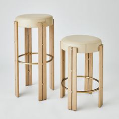 two stools made out of wood and leather