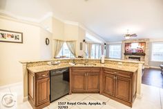 a kitchen with marble counter tops and wooden cabinets