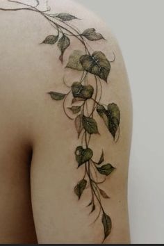 the back of a woman's shoulder with leaves on it