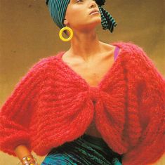 a woman in a red sweater and blue skirt with large hoop earrings on her head