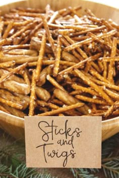 sticks and twigs in a wooden bowl with a sign that says sticks and twigs on it