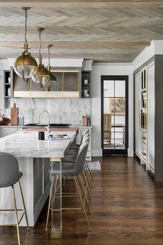 the instagram page shows an image of a kitchen with marble counter tops and gold accents