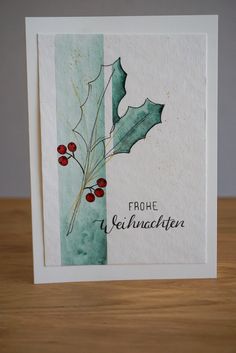 a christmas card with holly leaves and berries