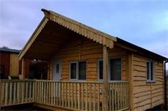 a small wooden cabin sitting on top of a parking lot