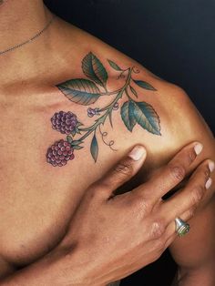 a woman's chest with flowers and leaves on it