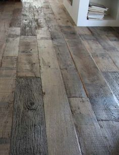 a wooden floor with white walls and wood floors