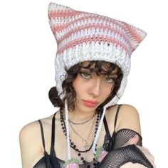 a woman wearing a white and pink knitted hat