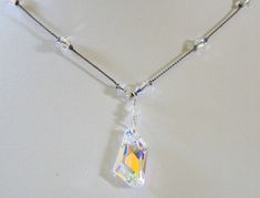 "Beautiful crystal AB Swarovski April birthstone necklace is hand knotted by me. Perfect gift for a April birthday or 15th anniversary gift for wife! I showcase the Crystal AB De-Art Pendant with Crystal AB Swarovski crystals handknotted on grey silk cord. The AB or aurora borealis is a fire polish on one side of the stone giving the effect of a rainbow of colors. The pictures don't do justice to the amount of sparkle these stones give off! Length is approximately 17.5\". Please contact me if yo Adjustable Crystal Necklaces For Anniversary, Crystal Pendant Necklace Single Strand Gift, Faceted Crystal Necklace As A Gift, Adjustable Faceted Crystal Necklace For Gifts, 15th Anniversary Gift, April Birthstone Necklace, April Birthday, Anniversary Gift For Wife, 15th Anniversary