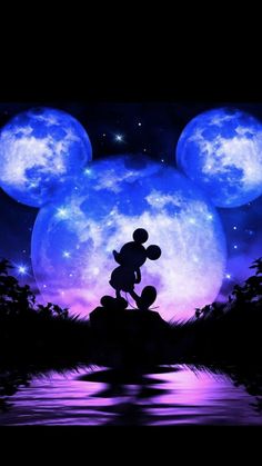 the silhouette of mickey mouse in front of a full moon and water scene with stars