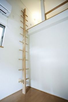 an empty room with a ladder leaning up against the wall