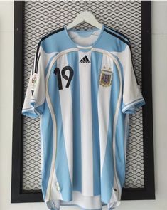 a soccer jersey hanging up on a wall