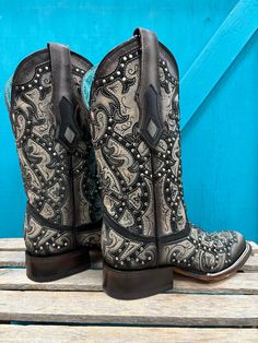 Exhibit your bold cowgirl style with Corral Women's Black Laser Embroidered & Studs Square Toe Cowgirl Boots, showcasing intricate embroidered detailing and studded accents. Authentic Cowgirl Style Cowhide Leather Vamp Pig Leather Lining Square Toe 12" Shaft Height Macocel 1.5" Cowboy Heel Leather Sole Goodyear Welt Construction Color: Black And Grey Western Style Embroidered Boots, Western Hand Tooled Boots For Festivals, Hand Tooled Fitted Boots For Western-themed Events, Hand Tooled Western Boots For Festival, Embroidered Snip Toe Boots For Rodeo, Western Embroidered Boots For Rodeo, Hand Tooled Fitted Boots For Rodeo, Fitted Hand Tooled Boots For Rodeo, Traditional Fitted Snip Toe Boots