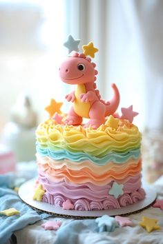 a colorful cake with a dinosaur on top