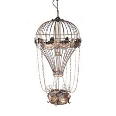 an ornate birdcage chandelier is hanging from the ceiling