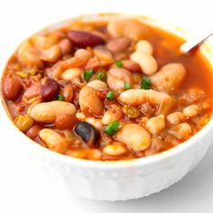 a white bowl filled with bean and vegetable soup