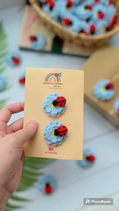 a person holding up a card with two ladybugs on it