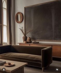 a living room filled with furniture and a chalkboard