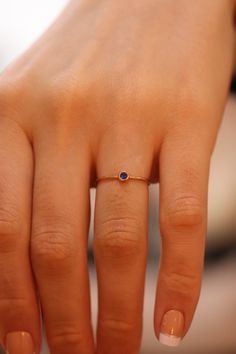 "Gold Sapphire Ring / Handmade Sapphire Ring / 14k & 18k Gold Minimalist Ring Available in Gold, Rose Gold, White Gold ❥ ITEM DETAILS ---> Gold Color of Choice : Yellow Gold, Rose Gold, White Gold ---> Material : 14k ( 585 ) or 18k ( 750 ) Real Gold. It is Not Gold Filled or Gold Plated ---> Made to order ---> Band Thickness : 1.20 mm ---> Band Width : 1.15 mm ---> Natural Sapphire ---> Sapphire Cut: Round ---> Number of Sapphire : 1 ---> Total Carat : 0.05ct ---&g Tiny 14k Gold Round Midi Rings, Dainty Rose Gold Sapphire Birthstone Ring, Dainty 14k Gold Sapphire Ring, Minimalist 14k Gold Round Sapphire Ring, Minimalist 14k Rose Gold Stackable Rings As Gift, Minimalist Round Midi Rings With Bezel Setting, Minimalist Round Sapphire Ring In 14k Gold, Minimalist Rose Gold Birthstone Ring, Minimalist Amethyst Birthstone Ring