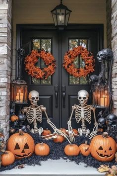 two skeletons sitting in front of a door decorated with pumpkins and decorations for halloween