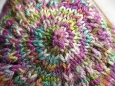 a close up view of a multicolored knitted hat