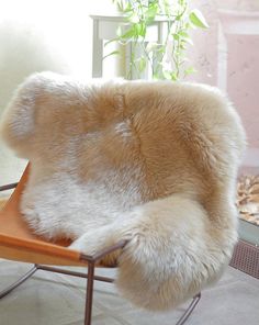 a chair that has some kind of animal fur on it's back and legs