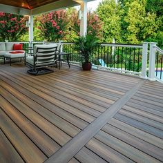 a wooden deck with chairs and tables on it