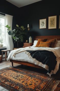 a bedroom with black walls and wooden furniture