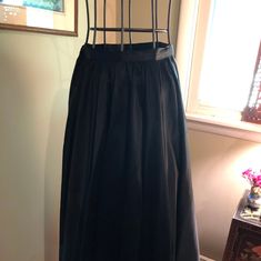 I am offering a beautiful 1950s black matte satin skirt. The skirt falls gracefully from its natural waistline. It is gathered. It is ankle length. It would be perfect as a recital skirt or for formal wear. It has a hook and snap closure. Measurements on request. Womens Skirts, Shirtwaist Dress, Matte Satin, Fall Skirts, Satin Skirt, Vintage Turquoise, Black Matte, Pink Cotton, Formal Wear