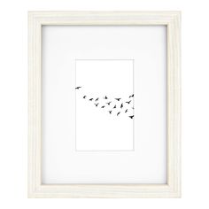 a black and white photo with birds flying in the sky above it, on a white background