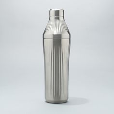 a silver vase sitting on top of a white table