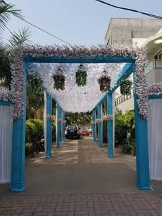 a blue and white wedding arch decorated with flowers