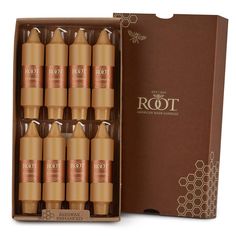 eight bottles of root oil in a cardboard box