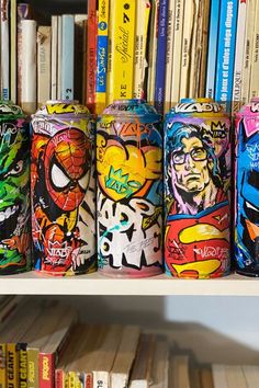 the bookshelf is filled with many different colored cans