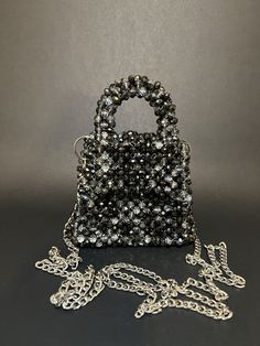 Beautiful, handcrafted beaded bag. This model uses space-gray Preciosa crystals. Size: 12x9x7 cm  /  5x3.8x3 inh The bag is strong enough to carry a lot of your daily essentials, shiny enough to make your evenings sparkle, and with its unique designs, you can be sure to stand out from the crowd.  I can create any size and colour bag by request, please write to DM to order your unique model. Gift Black Beaded Shoulder Bag, Rectangular Bag With Black Beads As Fashion Accessory, Silver Beaded Bag As A Gift, Silver Beaded Bags As Gift, Silver Beaded Bags Suitable For Gifts, Rectangular Bag With Beaded Chain For Gift, Rectangular Bags With Beaded Chain For Gift, Silver Beaded Shoulder Bag As Gift, Silver Beaded Shoulder Bag For Gift