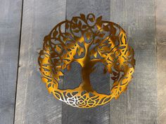 a decorative metal tree on a wooden surface